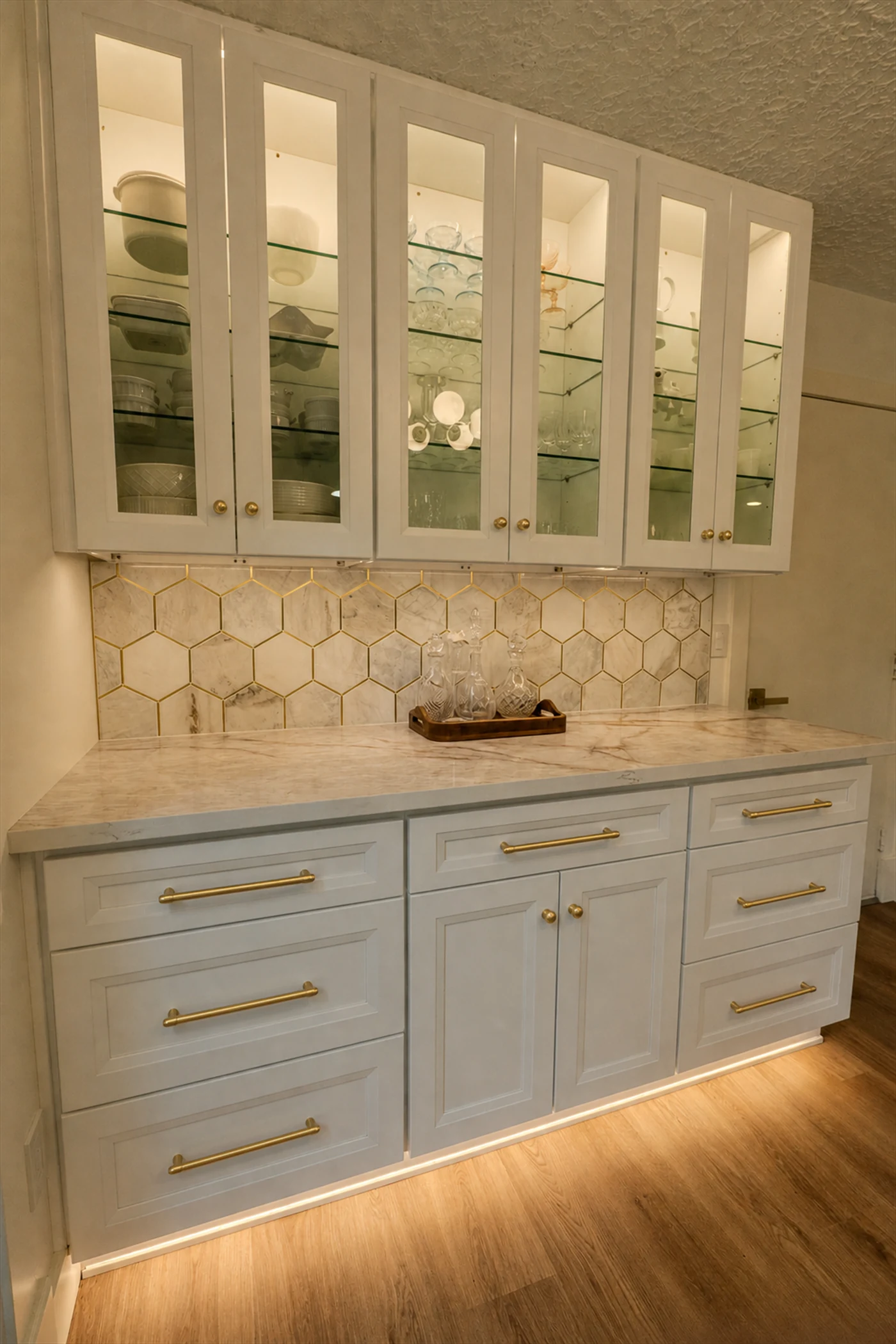 Custom bar cabinetry with glass doors, marble countertop, and brass hardware, Portland OR kitchen remodel